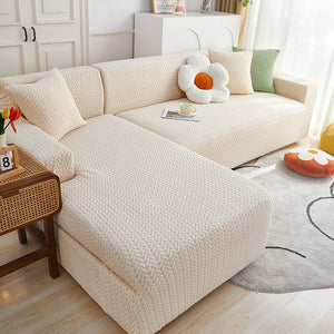 A beige sofa slipcover with a checkered design fitted on a sofa, accompanied by anti-slip foam rods, in a room setting with decorative items.